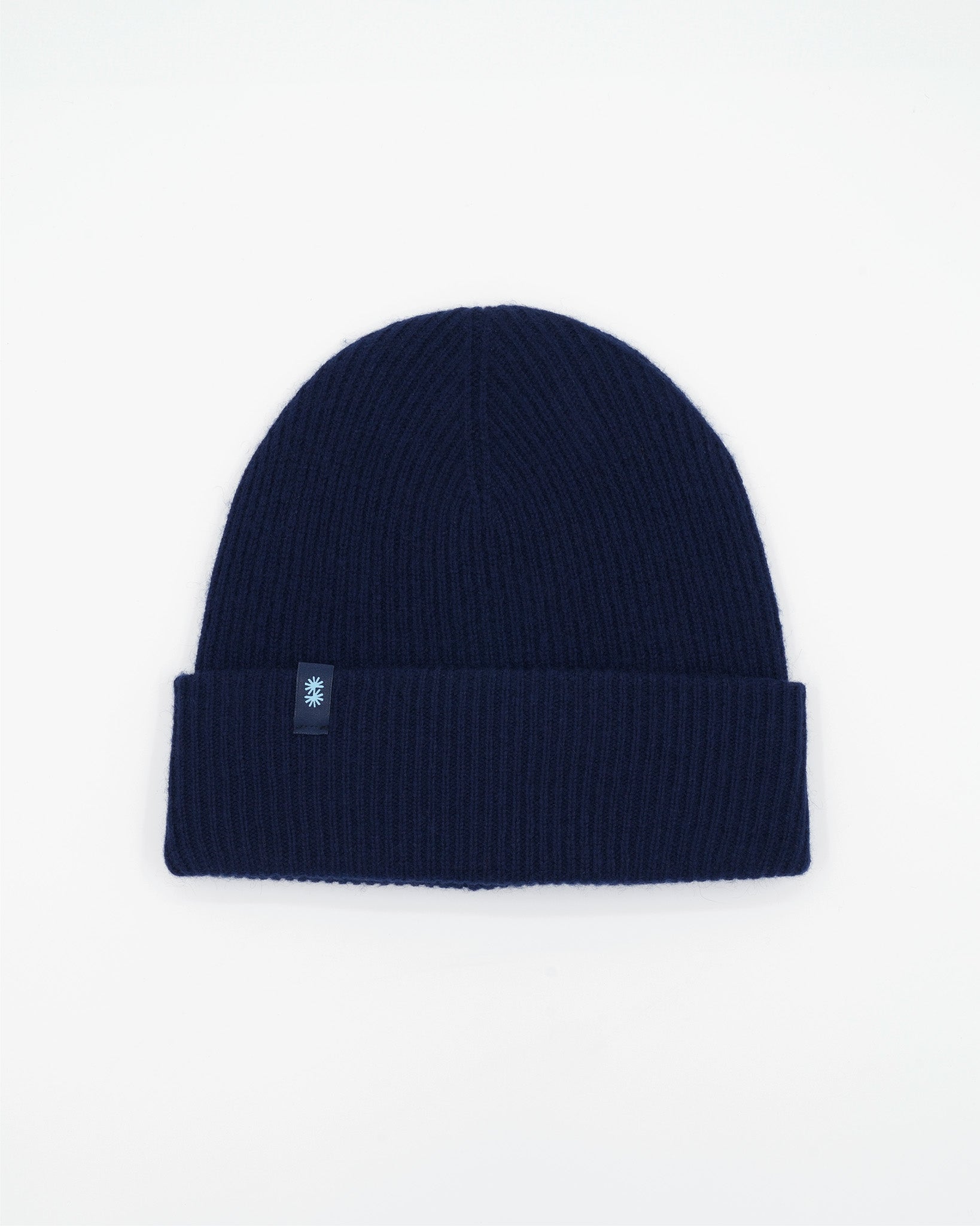 Dark blue cashmere merino wool beanie with yellow woven label front