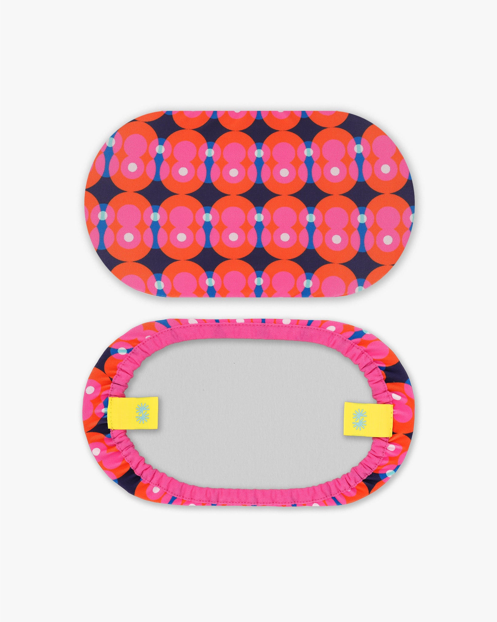 Front and back view of a goggle cover with a bright pink and red circles on dark blue background geometric print