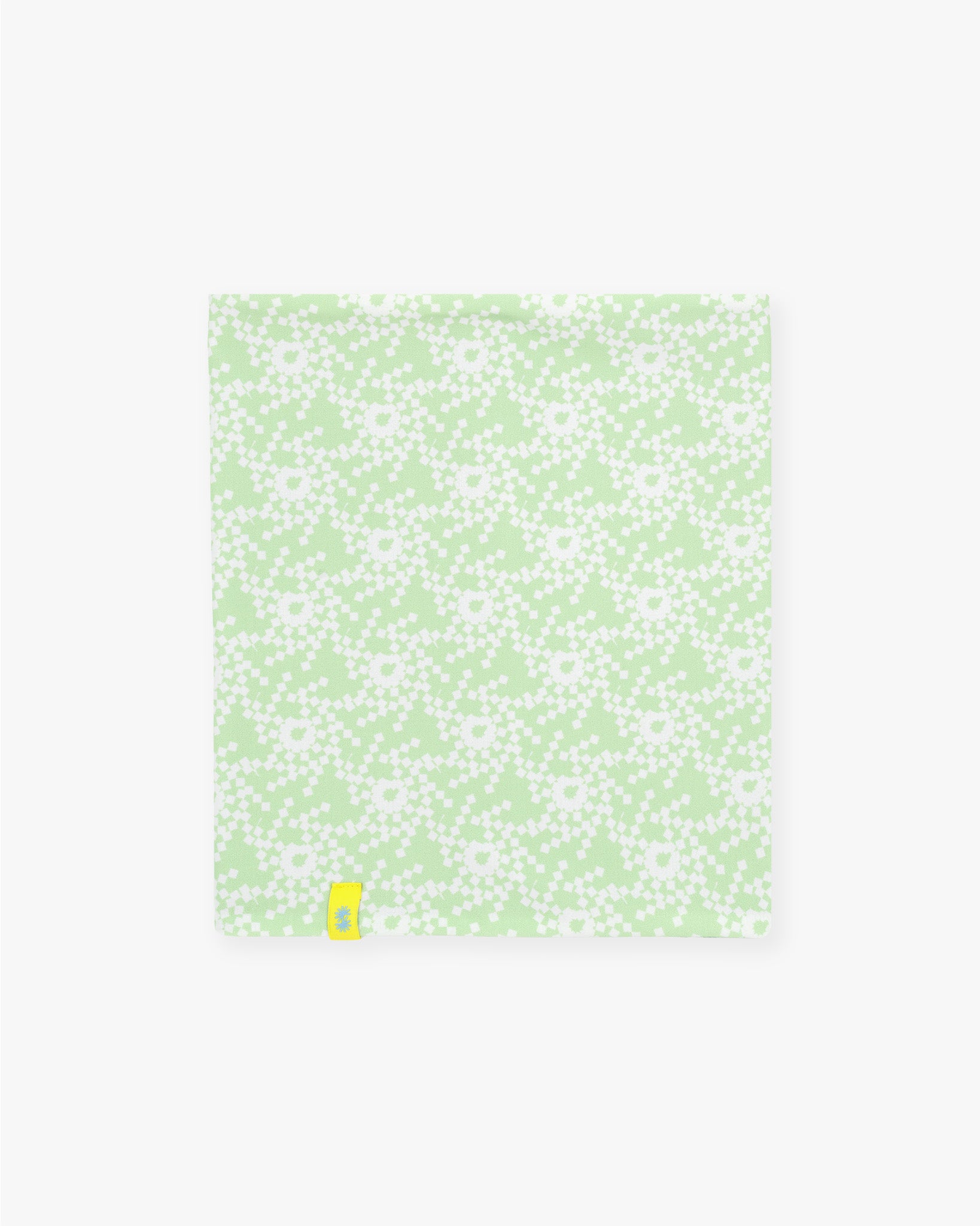 Front view of a double layer neck warmer with green and white geometric snowflake printed lycra, green fleece lining and yellow woven CTW logo label