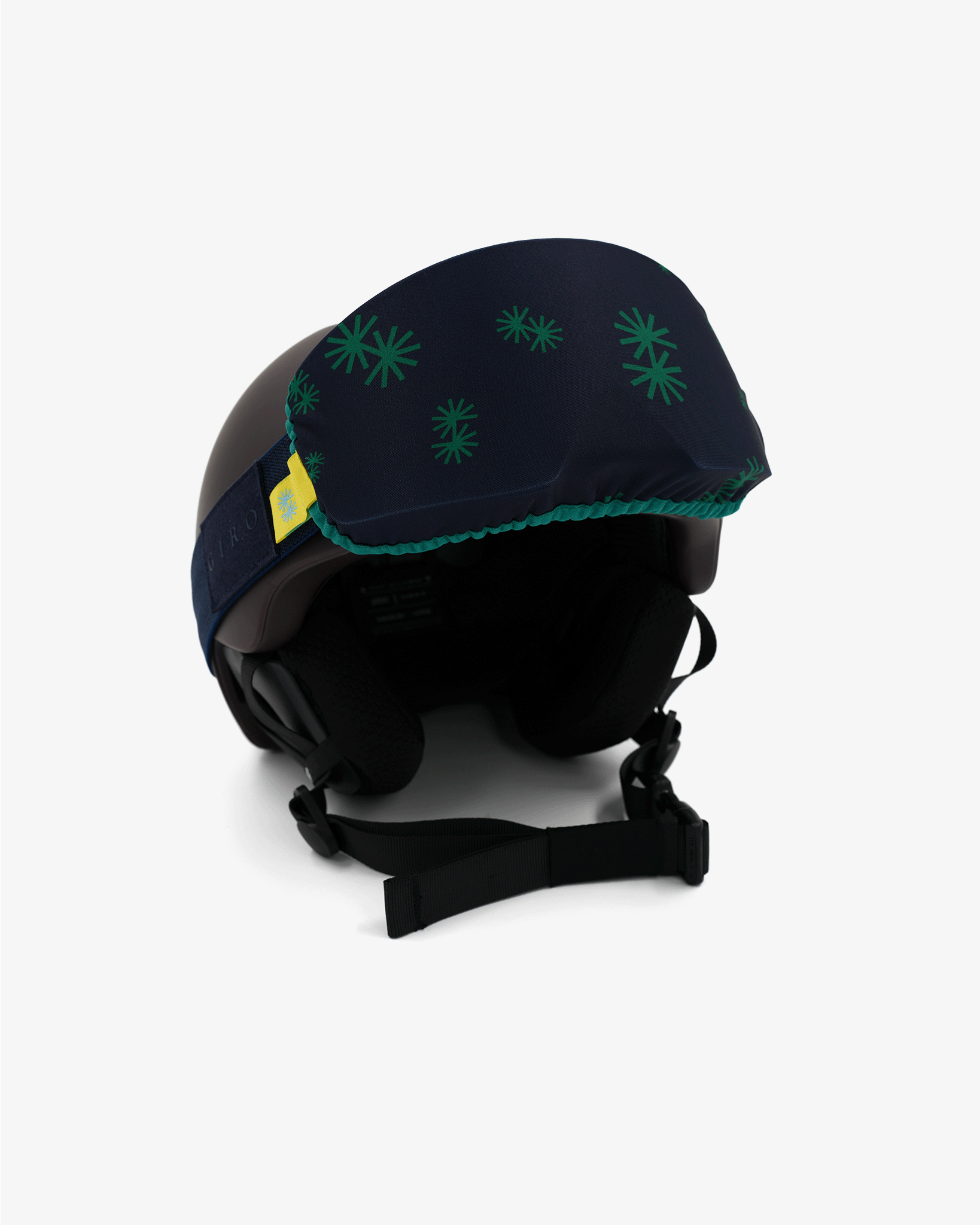 Helmet with goggles covered with a goggle cover with green snowflakes on dark blue background geometric print