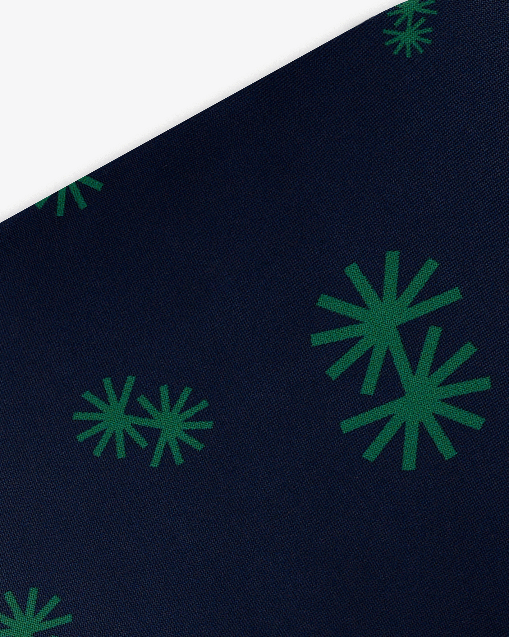 Goggle cover with green snowflakes on dark blue background geometric print close-up