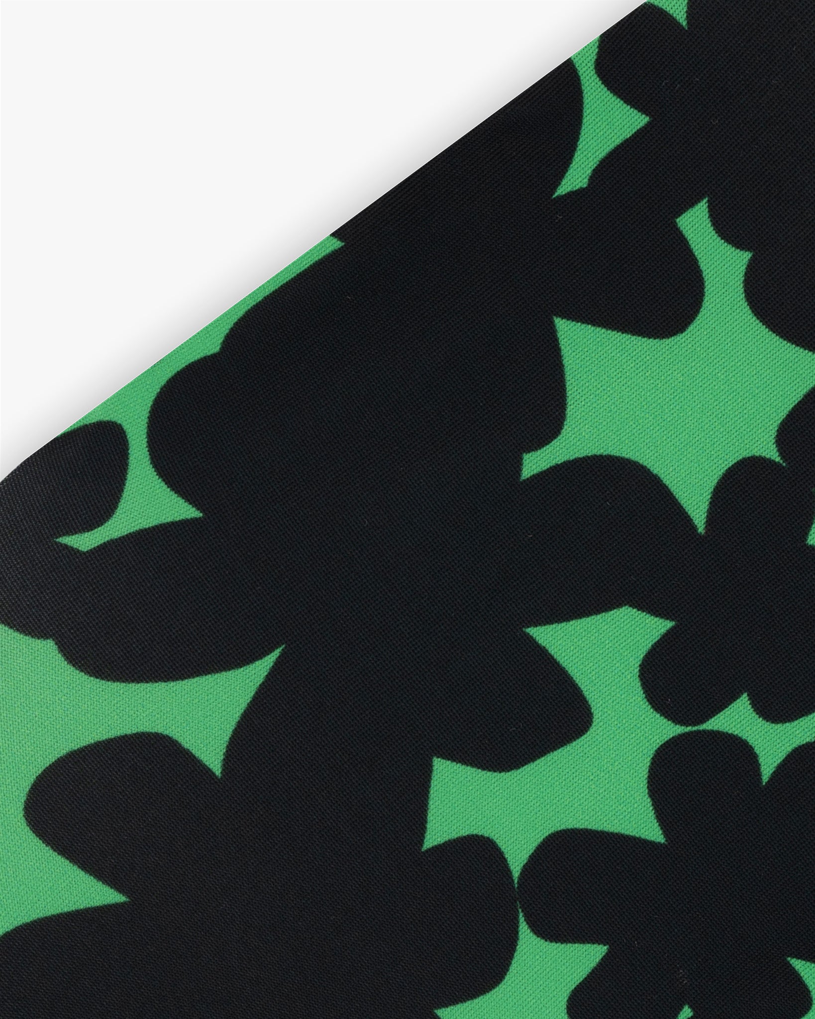 Goggle cover with green and black floral print close-up