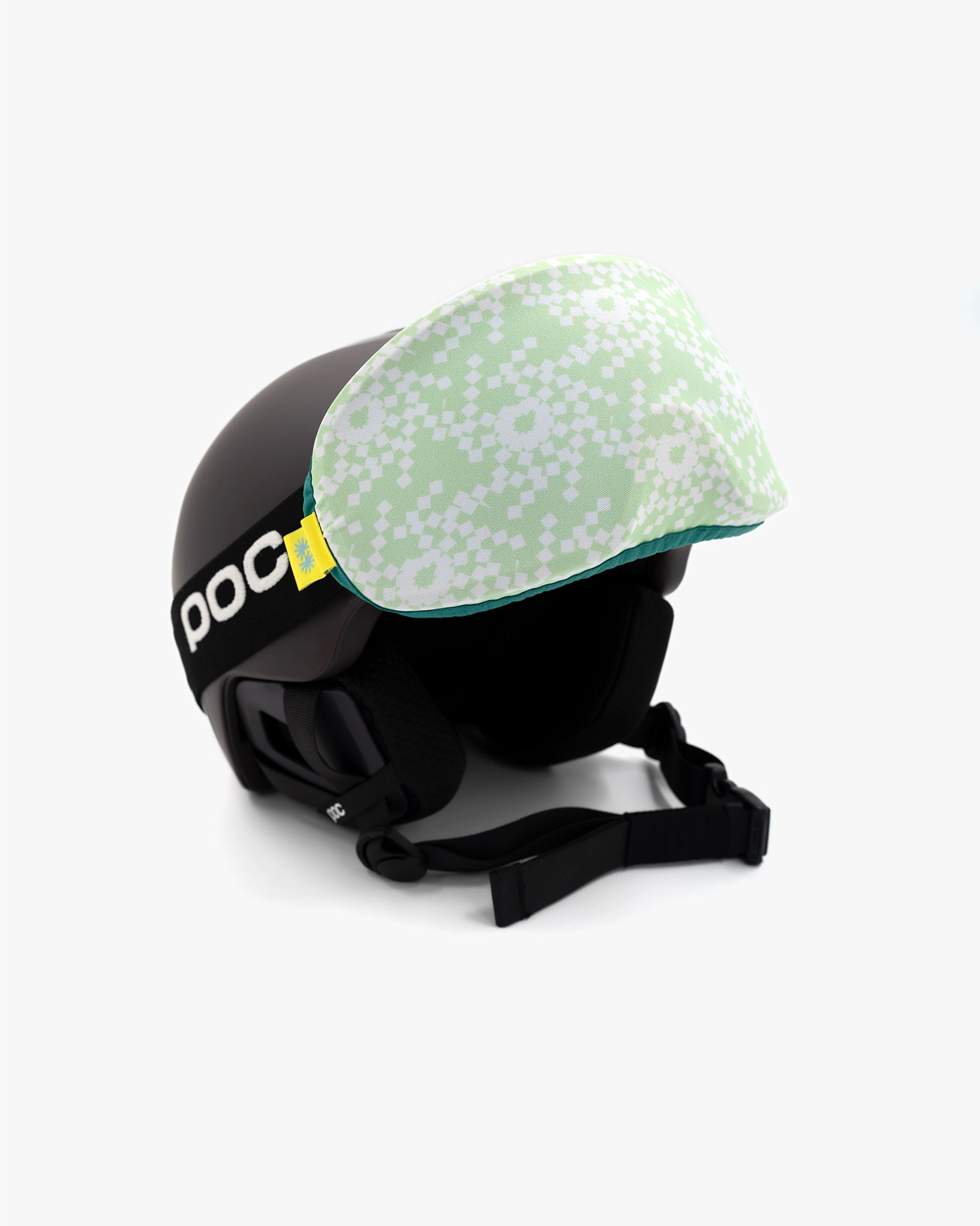 Helmet with goggles covered with a goggle cover with green and white geometric snowflake print