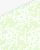 Goggle cover with green and white geometric snowflake print close-up