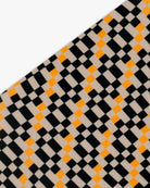 Goggle cover with black, orange and beige checkered print close-up