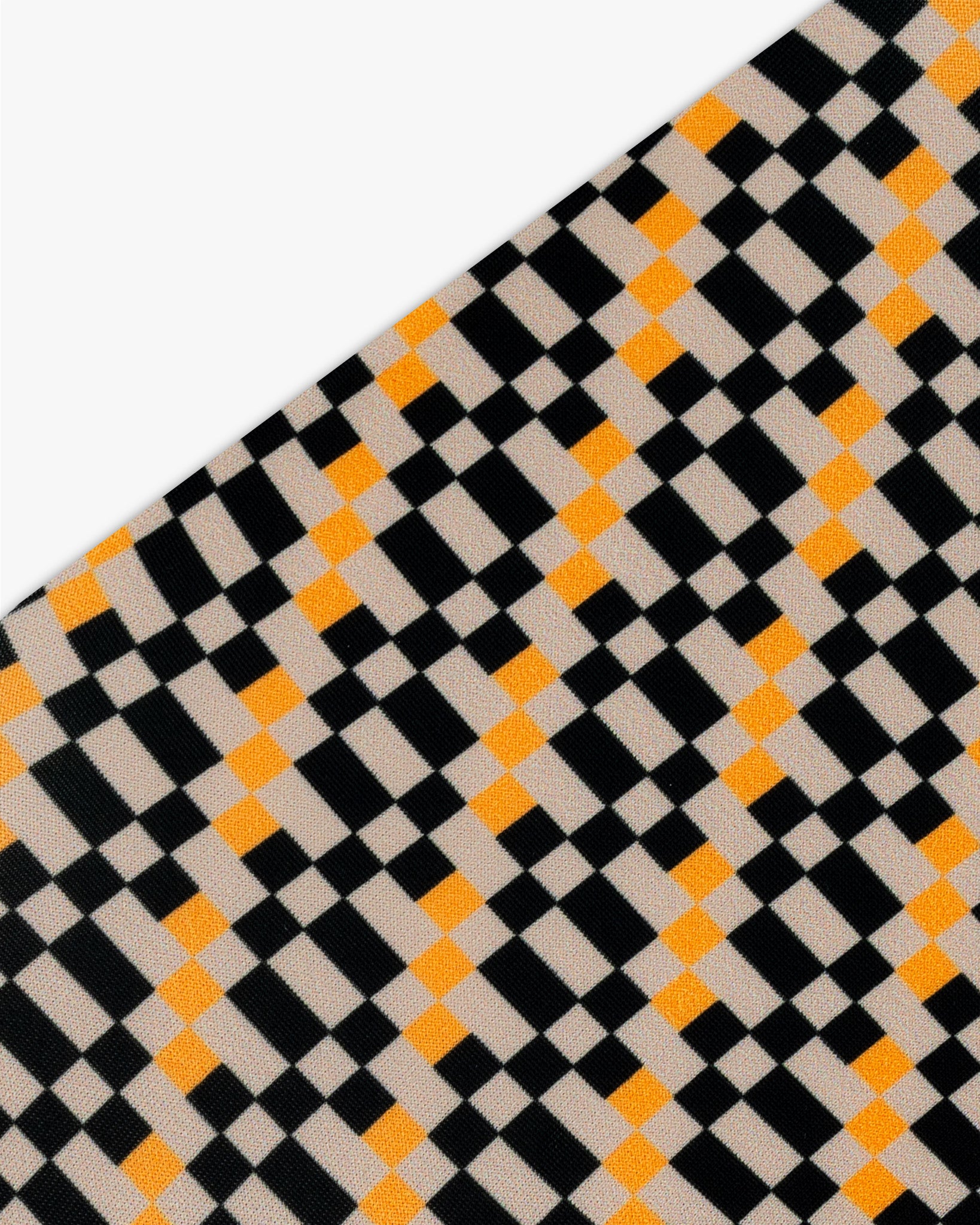 Goggle cover with black, orange and beige checkered print close-up