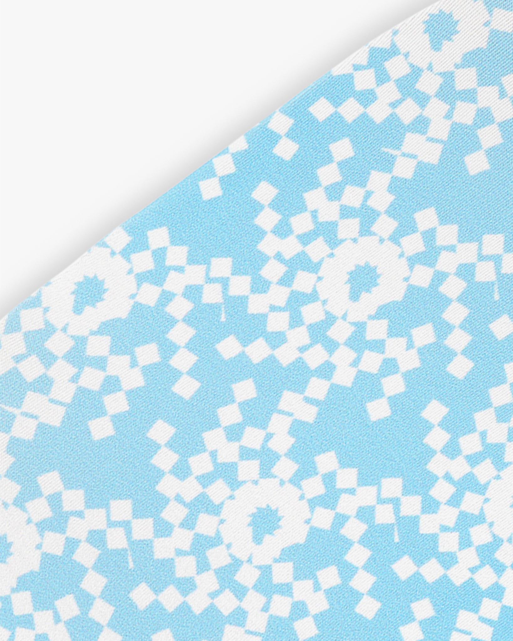 Goggle cover with blue and white geometric snowflake print close-up