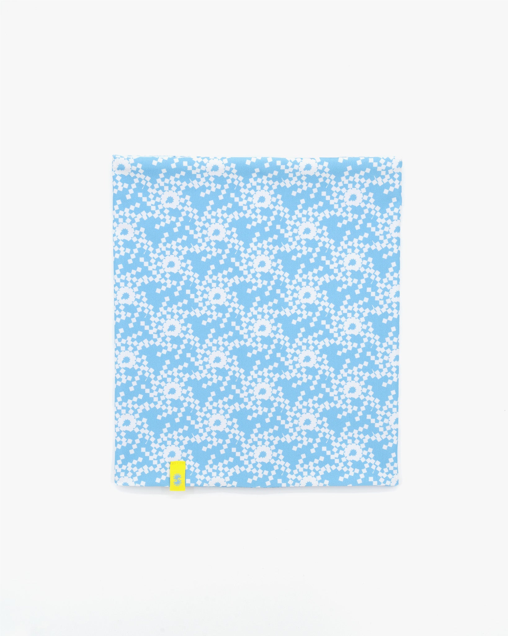 Front view of a double layer neck warmer with blue and white geometric snowflake printed lycra, blue fleece lining and yellow CTW logo woven label