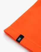 Electric orange polartec fleece short neck warmer with black CTW woven logo close-up