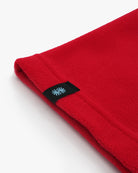 Deep red polartec fleece short neck warmer back woven CTW logo close-up