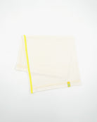 Folded view of a long off-white Power Wool neck gaiter, with a yellow back seam and yellow CTW logo woven label