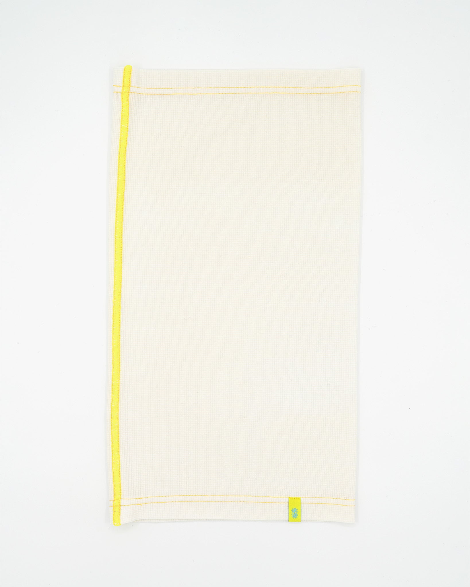 Side view of a long off-white Power Wool neck gaiter, with a yellow back seam and yellow CTW logo woven label